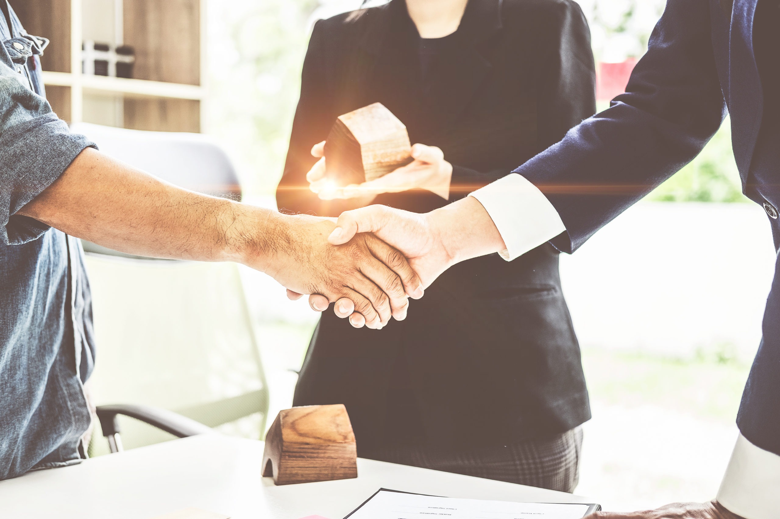Agent and customer meeting and handshaking after good deal for buy house. Agreement and Real estate concept.